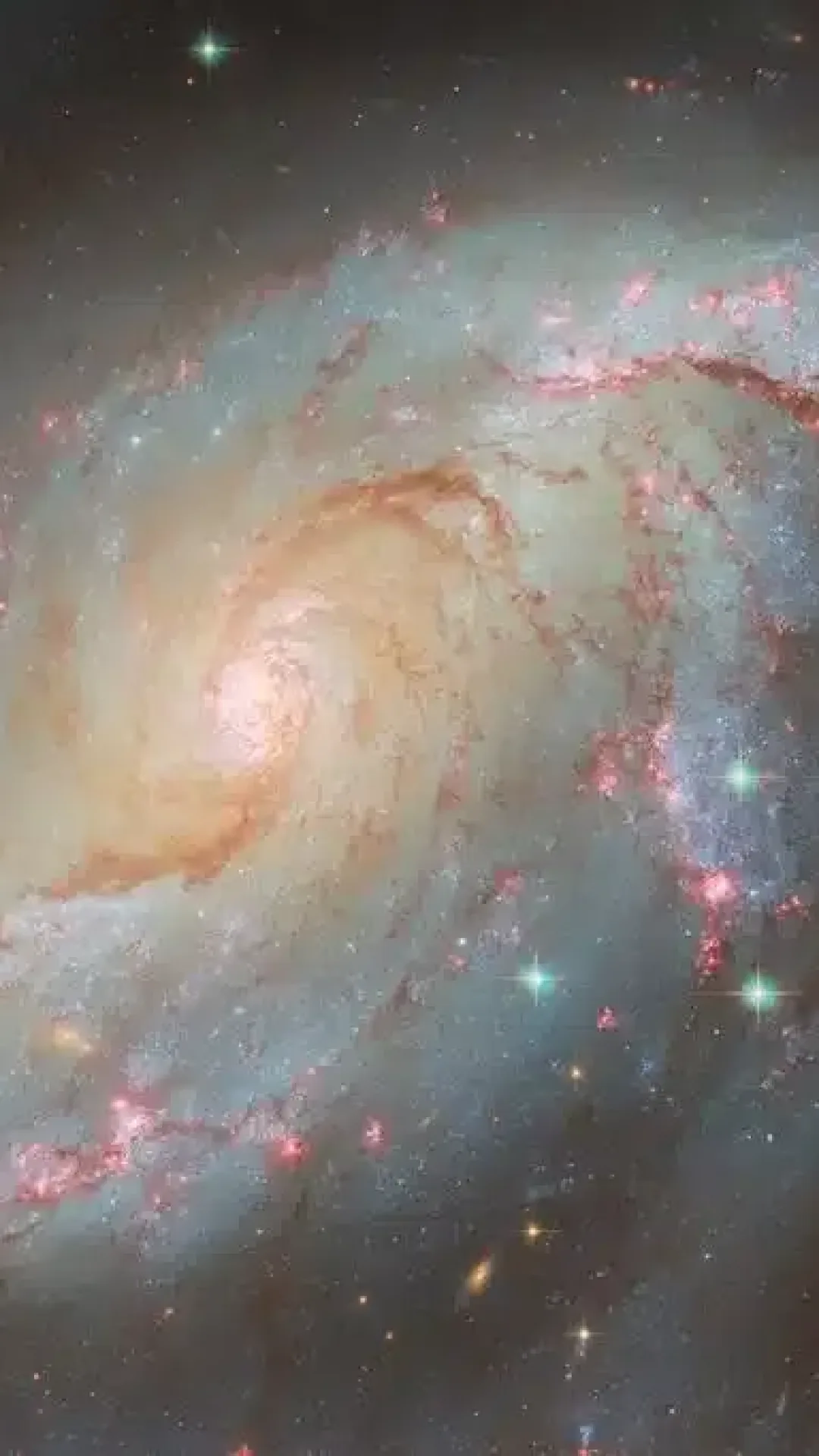 O telescópio espacial Hubble captura uma galáxia espiral com uma infinidade de luzes diferentes e chamativas
